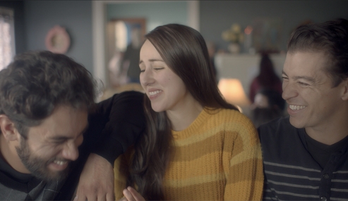 Three young adults laughing