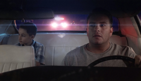 Father pulled over by officer. Young son in back seat